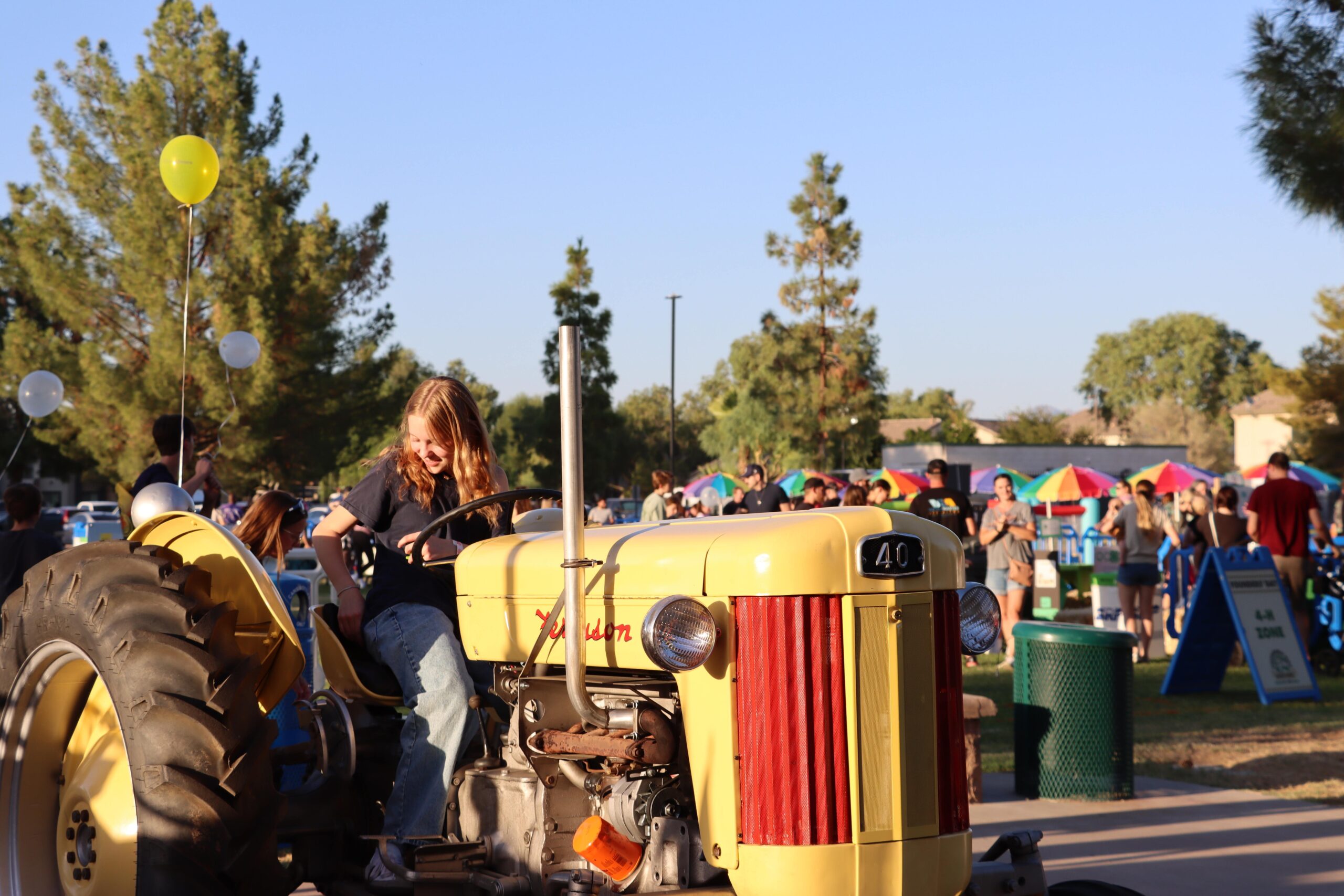 girl sitting on tractor at event