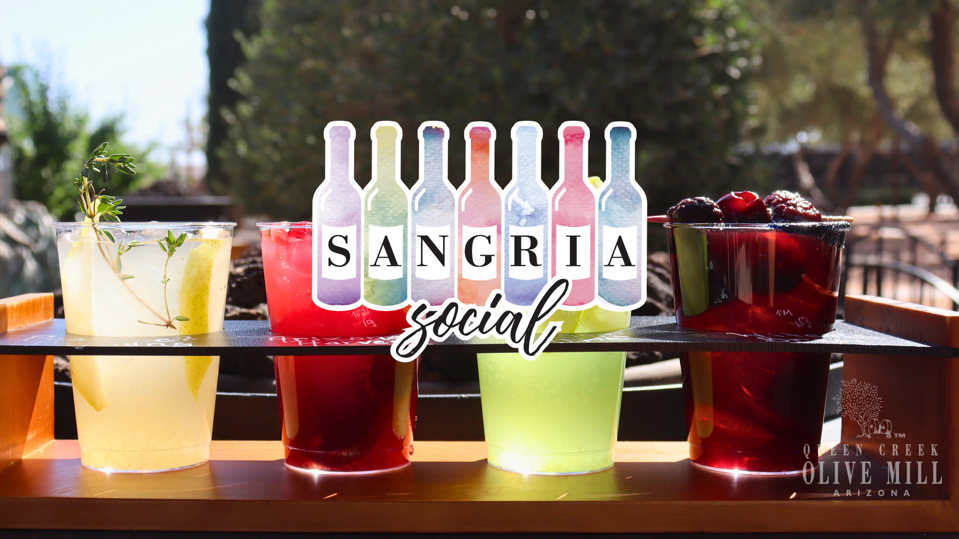 Sangria Social; logo in front of multicolor drinks in the grove.